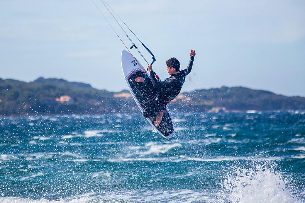 Kitesurfer jumping over waves